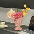 Pink ceramic scalloped vase with bow detail and flowers