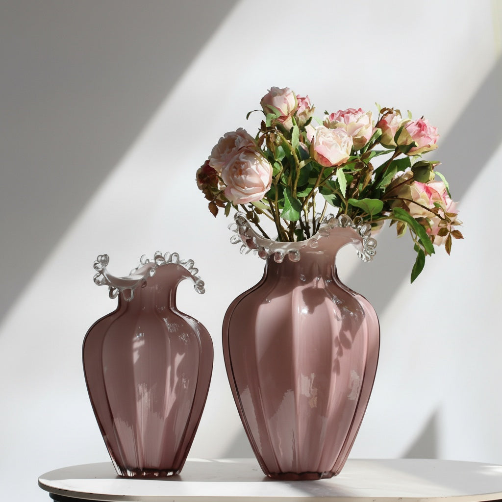 Pink glass fluted vase with ruffled rim and flowers