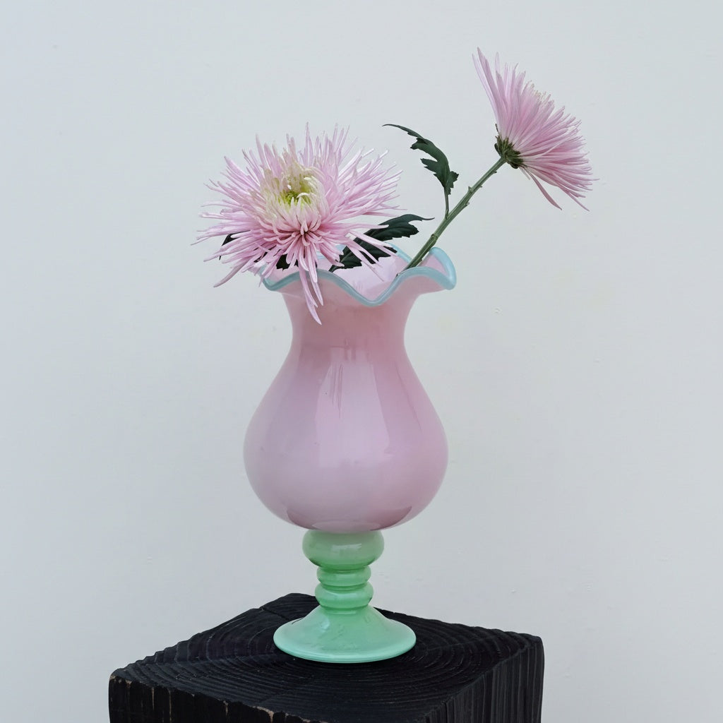 Front view of pink and green glass vase with flowers