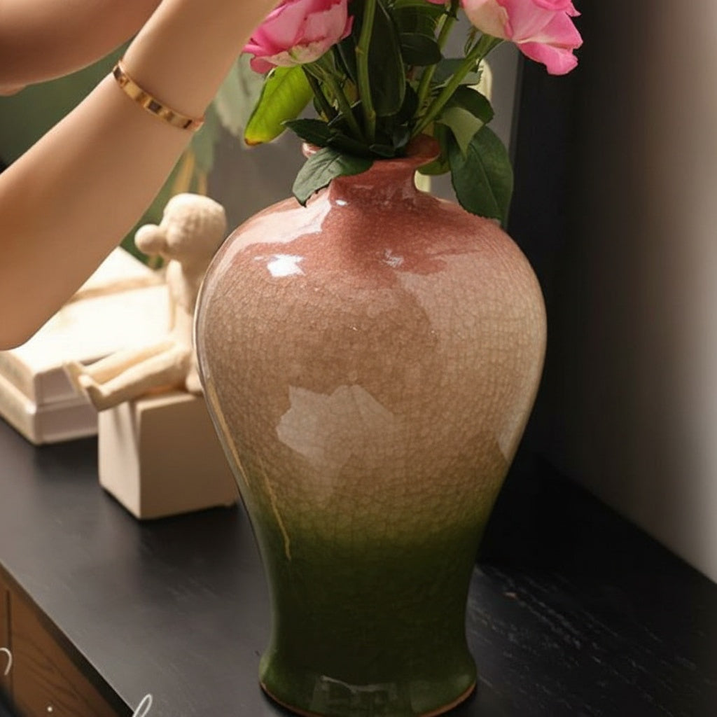 Person arranging pink roses in gradient ceramic vase