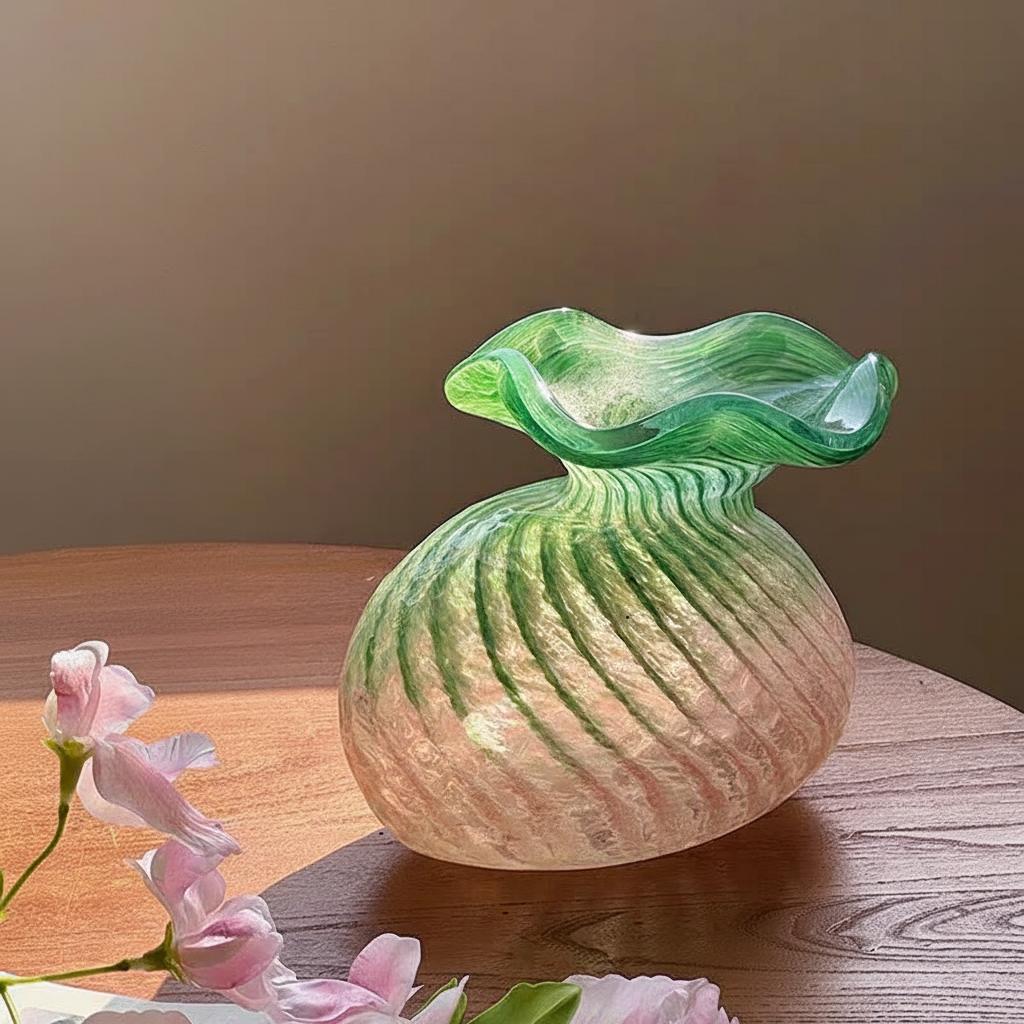Side profile of swirled texture pink and green glass vase