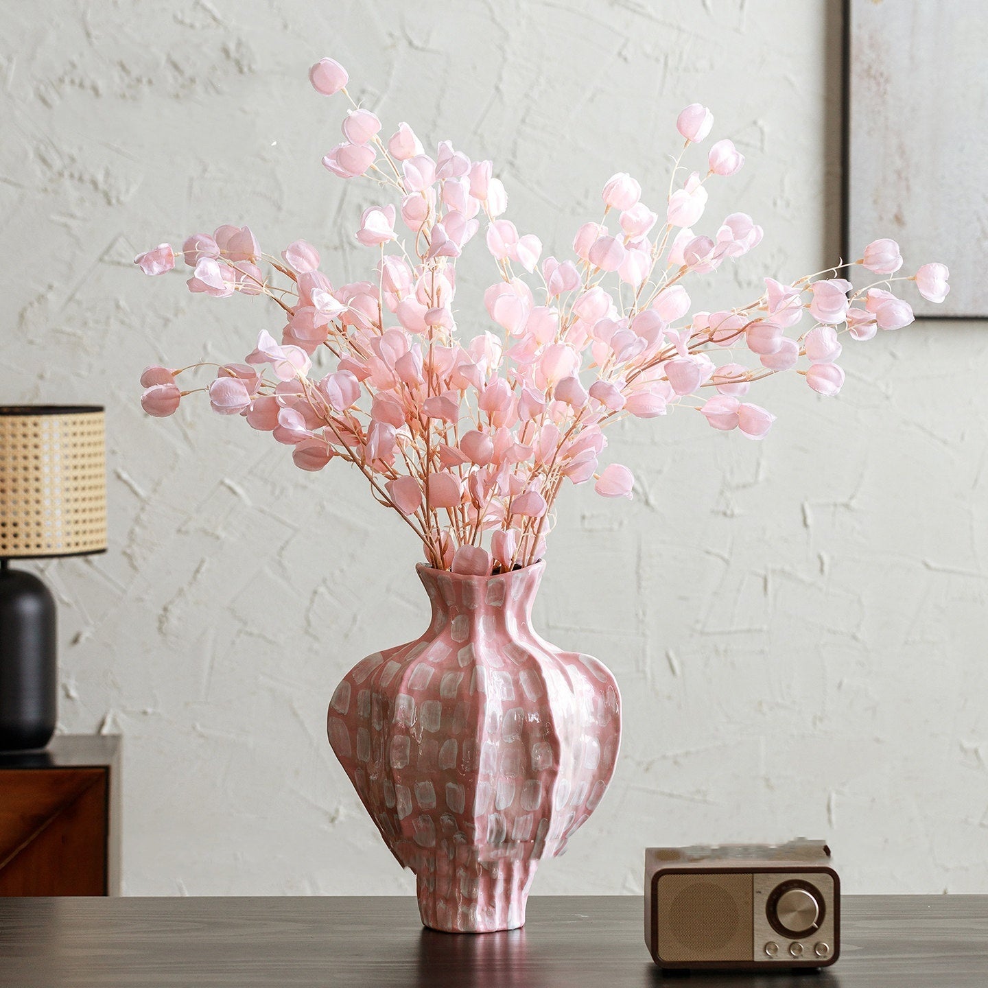 Large pink patterned ceramic vase styled with delicate pink flowers