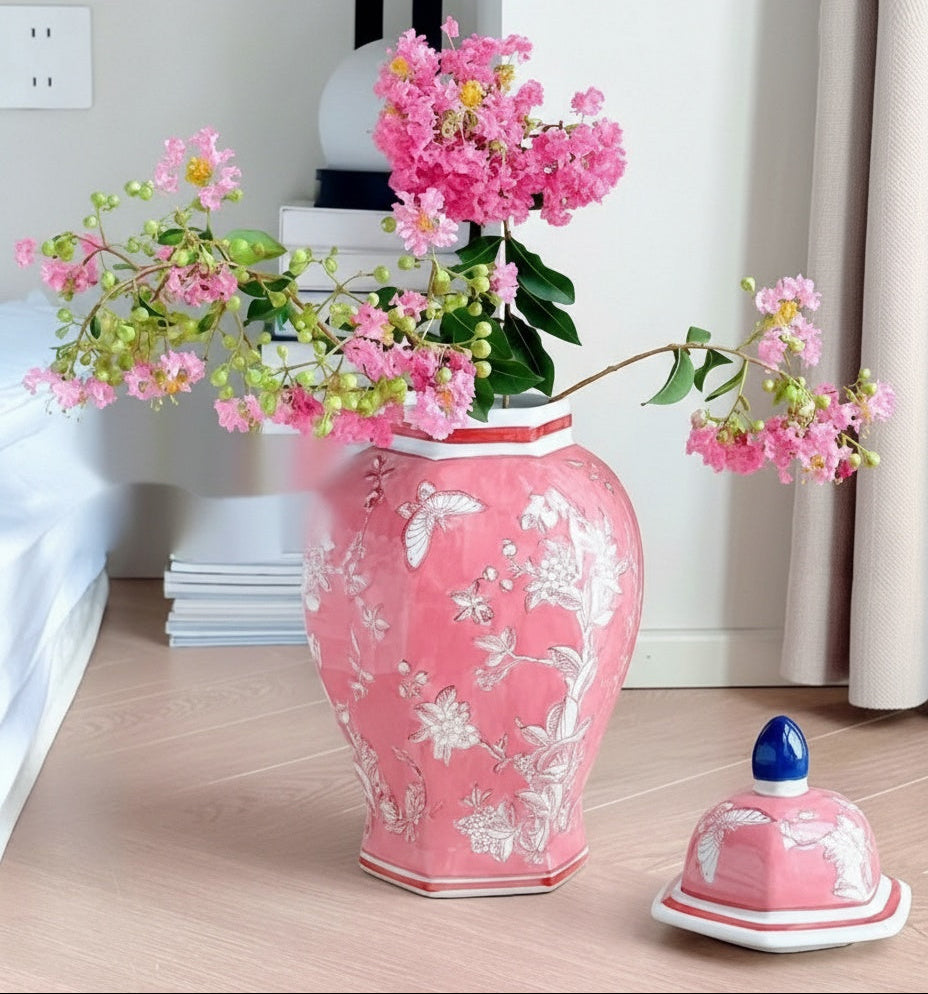 Pink faceted ceramic jar on floor with lid removed