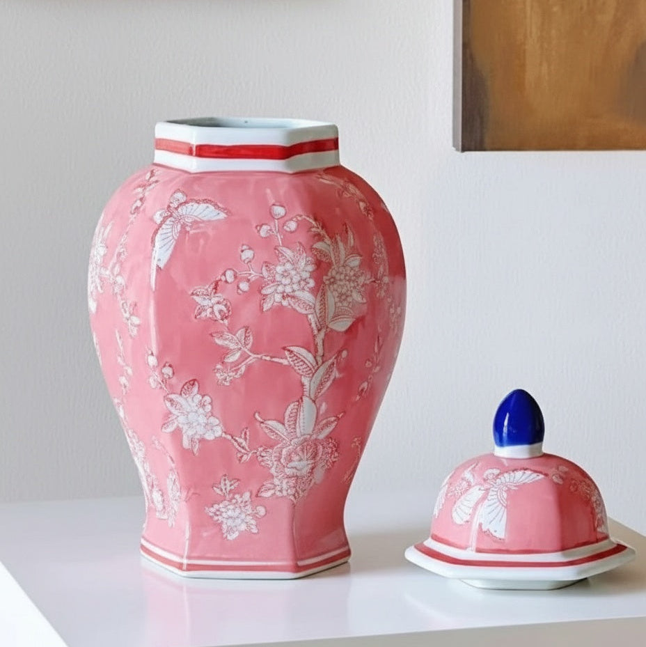Close up of pink floral porcelain jar and blue finial lid