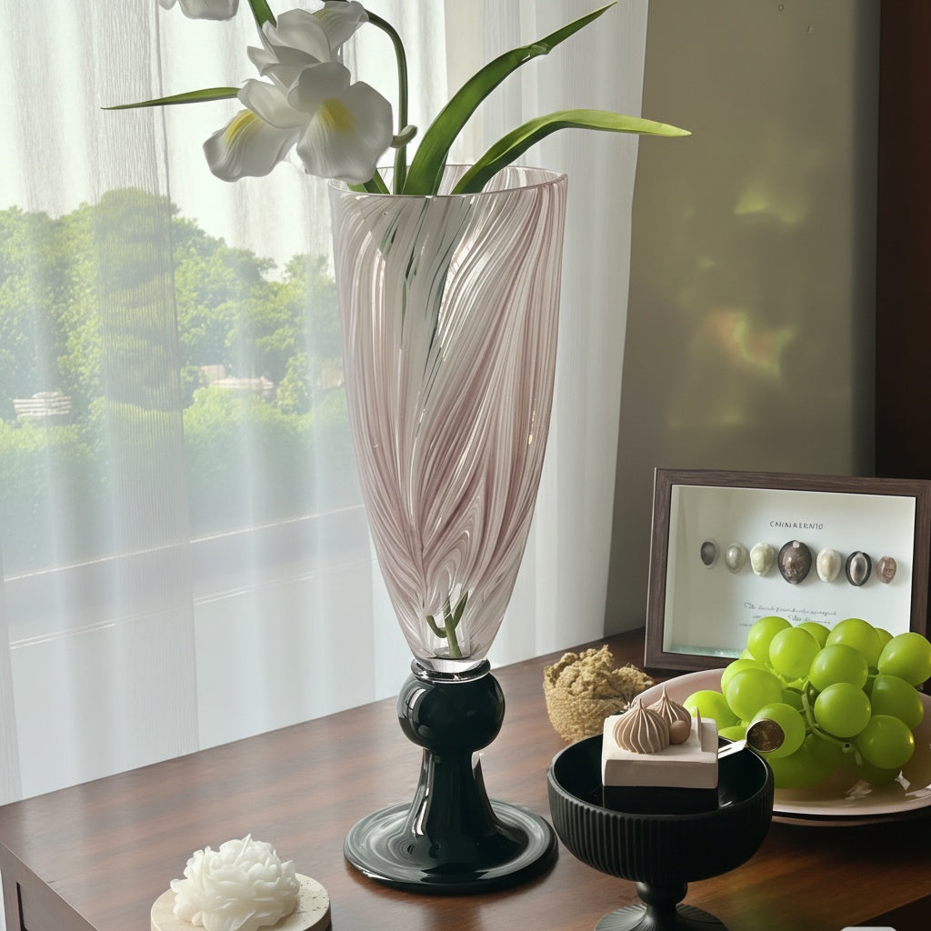 Full view of pink and white swirl glass vase with black base