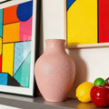 Pink textured ceramic vase with modern art background