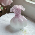 Pink and white swirled glass vase with ruffled rim top down view