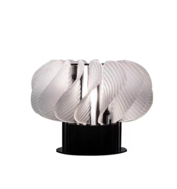 Front view of white pleated resin table lamp with black base