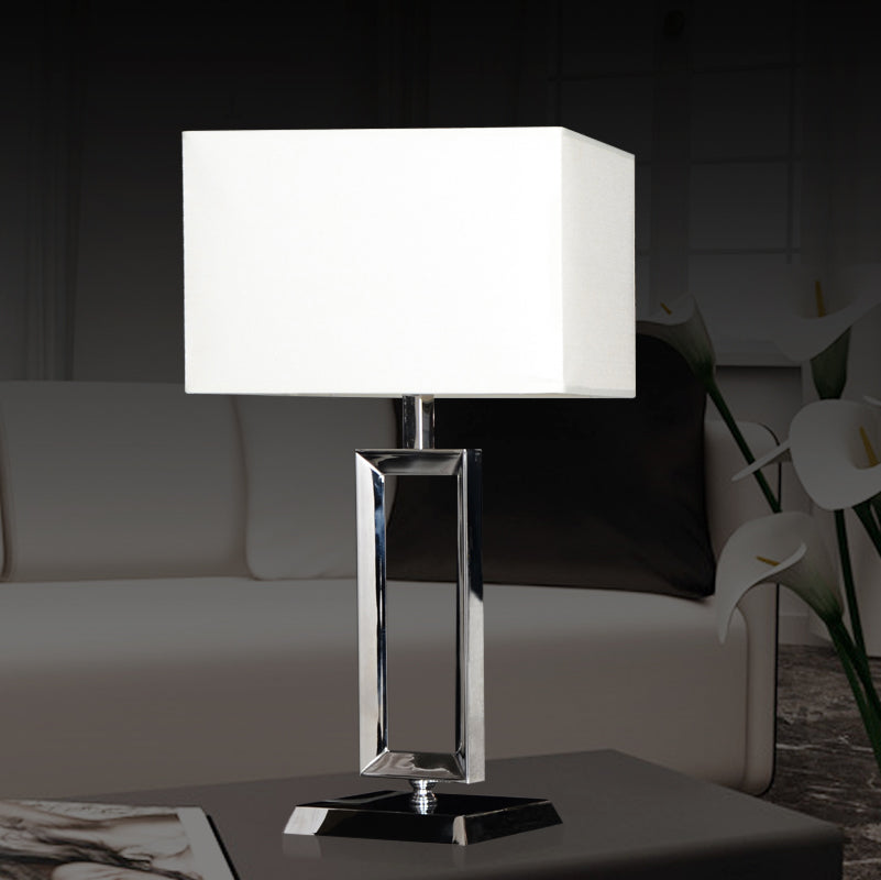 Front view of polished chrome rectangular table lamp with white shade