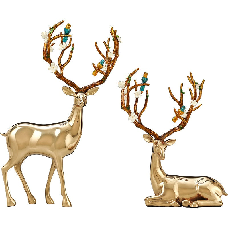 Pair of polished copper deer sculptures standing and sitting