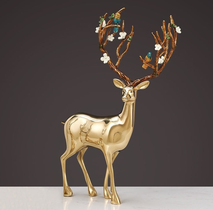 Side view of standing gold finish deer statue