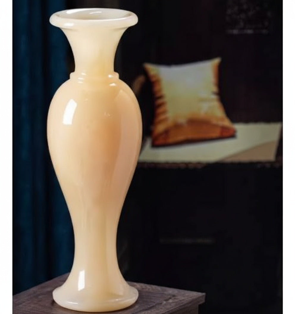 Polished cream onyx baluster vase on wooden table