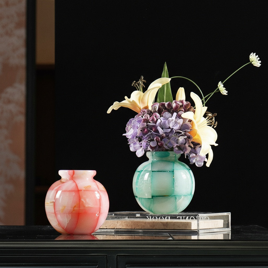 Group shot of pink and green mosaic spherical vases with flowers