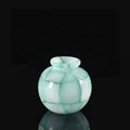 Close up of green translucent mosaic round vase