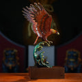 Side profile of copper eagle sculpture on wave