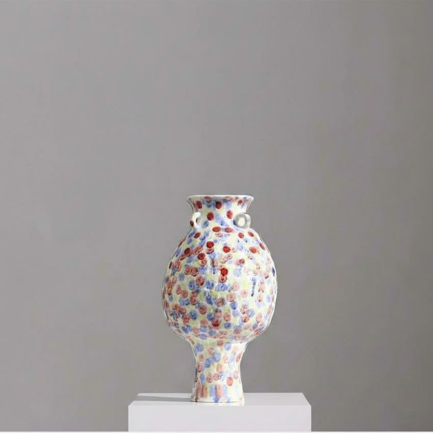 Detail view of ceramic vase with colorful dotted glaze