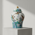 Front view of porcelain ginger jar with bird and floral patterns on white background