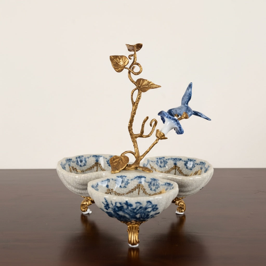 Front view of crackle porcelain trefoil centerpiece with brass bird sculpture