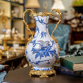 Blue and white porcelain vase with brass handles and bird motif