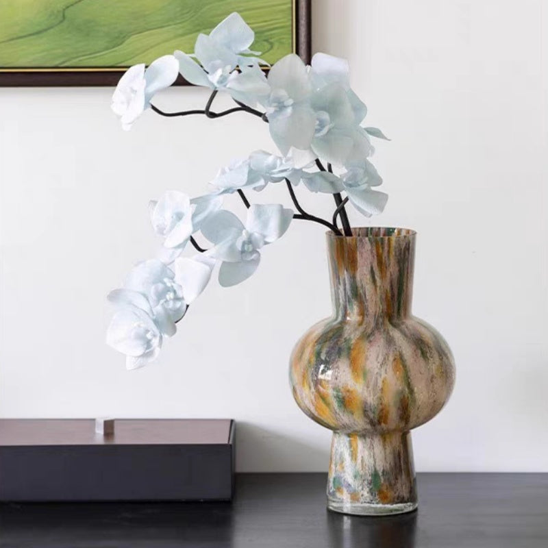 Wide shot of bulbous glass vase in interior setting