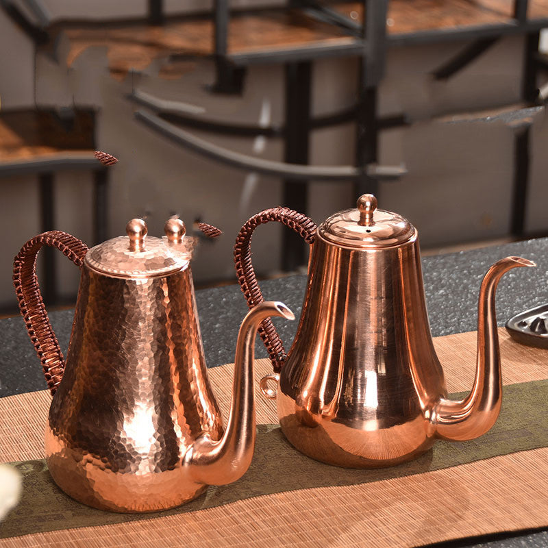 Pair of luxury copper kettles in smooth and hammered finishes