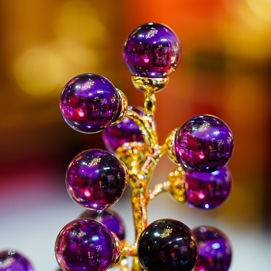 Close up of purple glass spheres and gold finished metal detailing