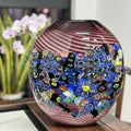 Front view of purple swirl art glass vase with mosaic band