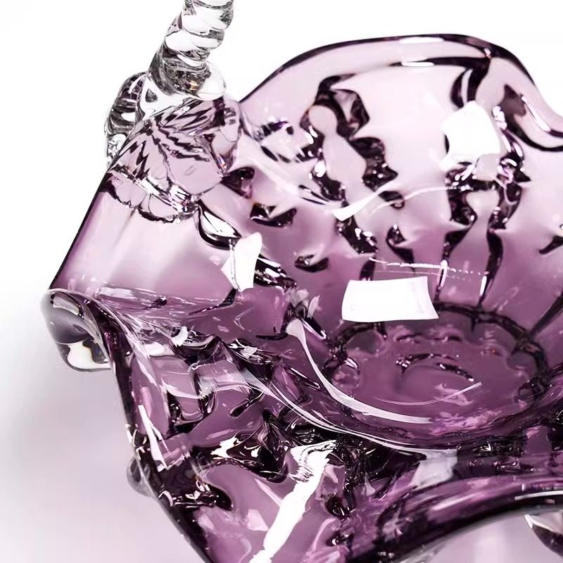 Detail of floral motif on purple glass handle