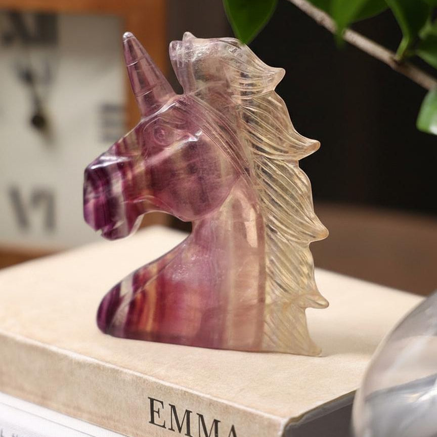 Detailed view of purple and gold banding on fluorite unicorn carving