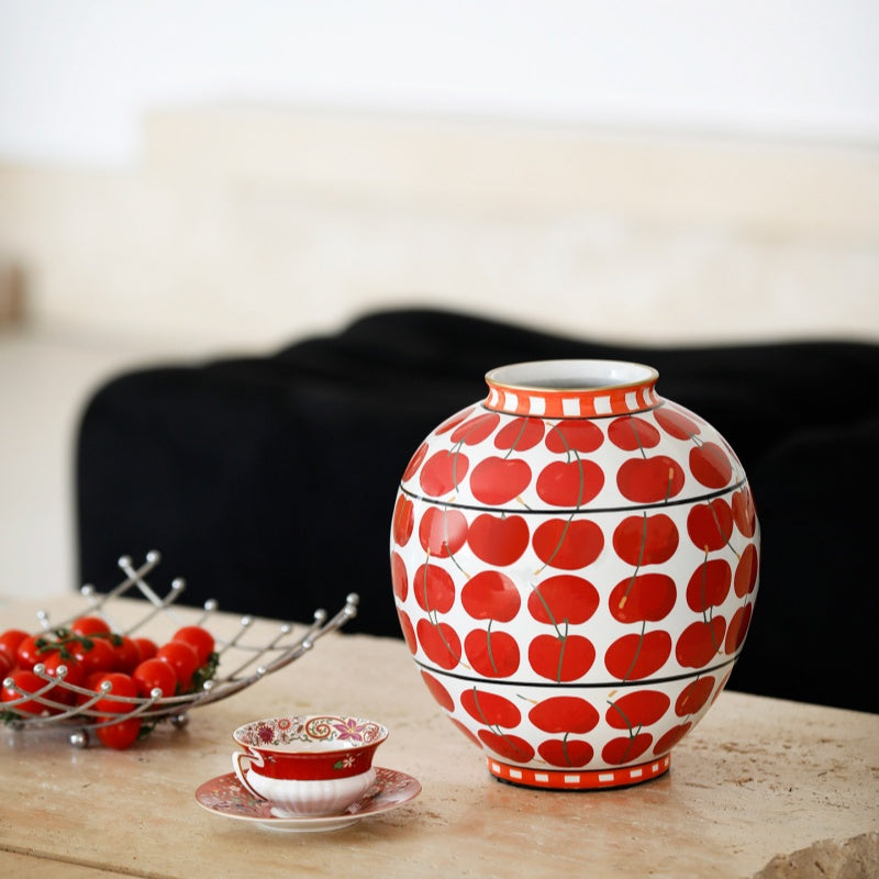 Angled view of red and white patterned vase on travertine coffee table