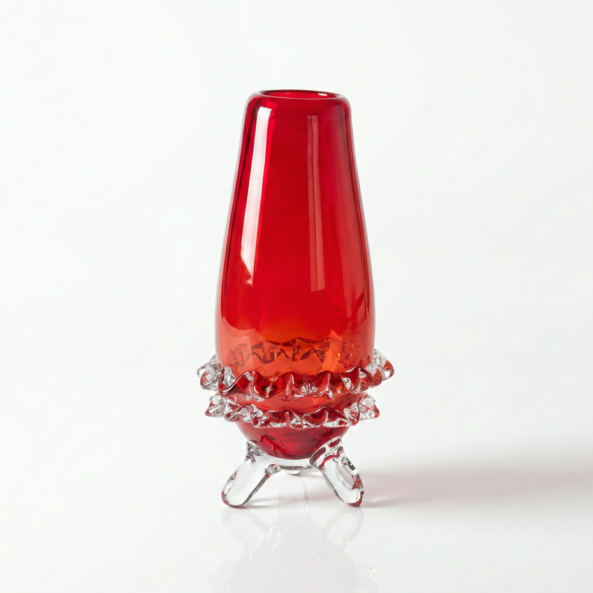 Tall red glass vase with clear ruffled feet