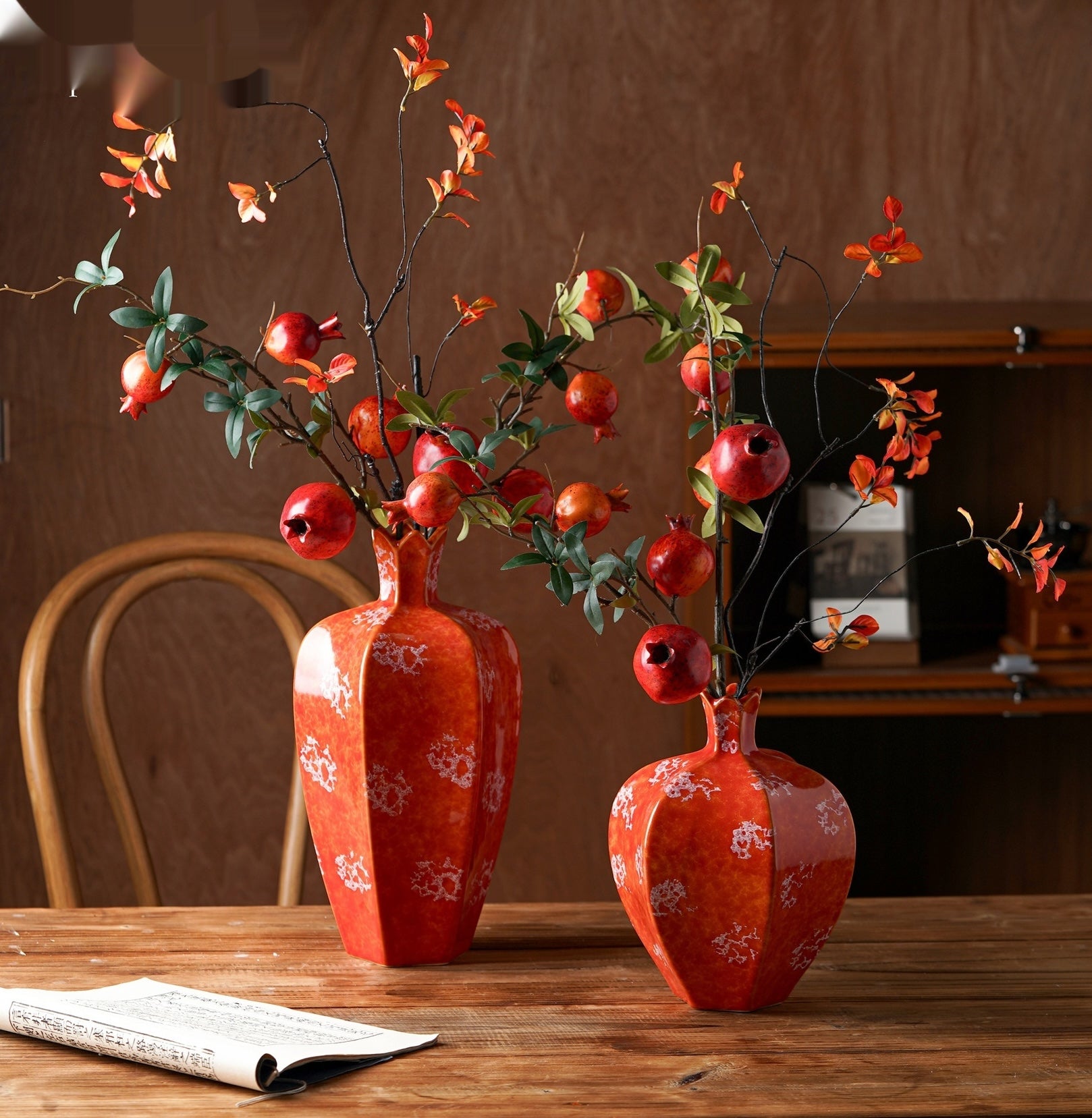 Set of two red mottled ceramic pomegranate vases styled