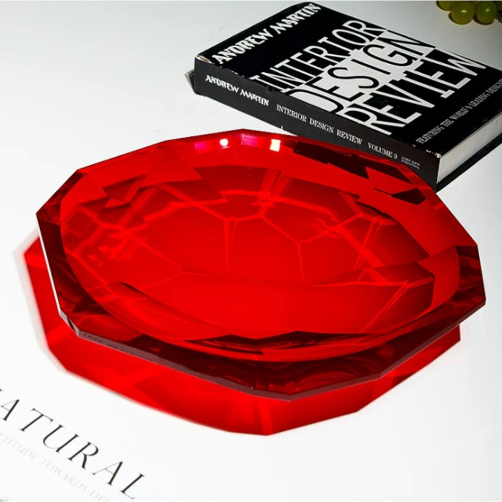 Ruby red crystal glass decorative bowl with faceted rim styled on books for elegant home decor