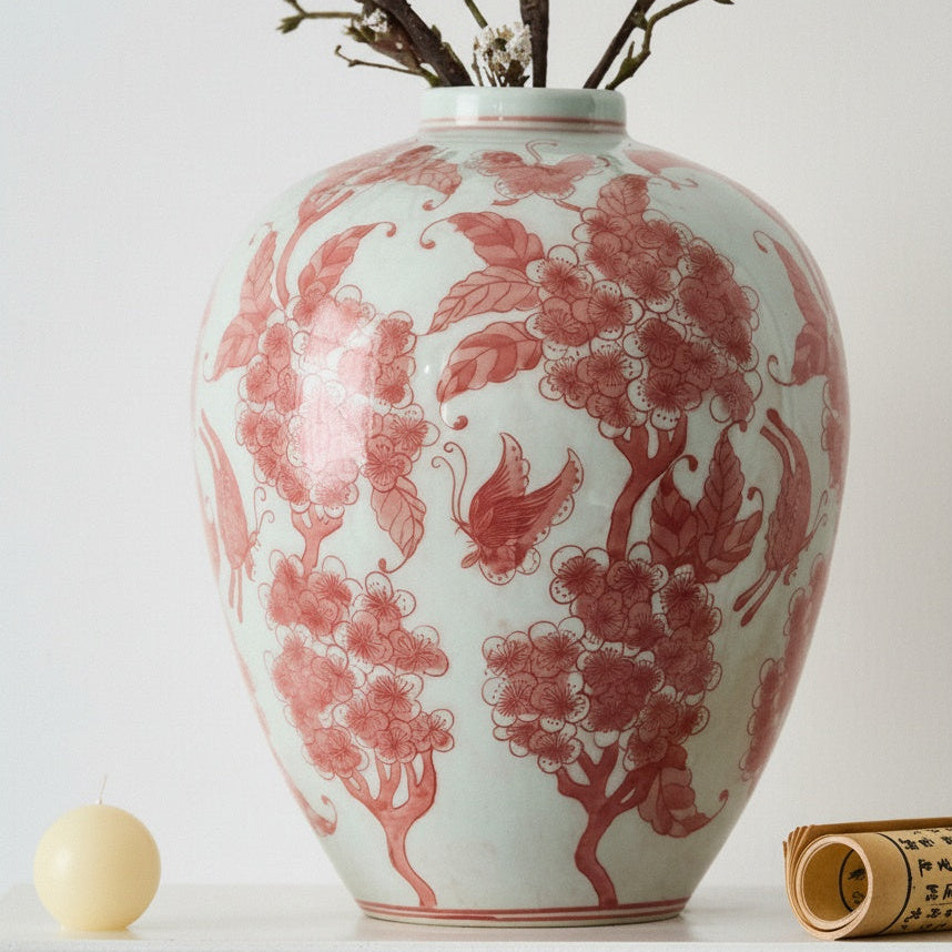 Close up of red floral porcelain vase with branches