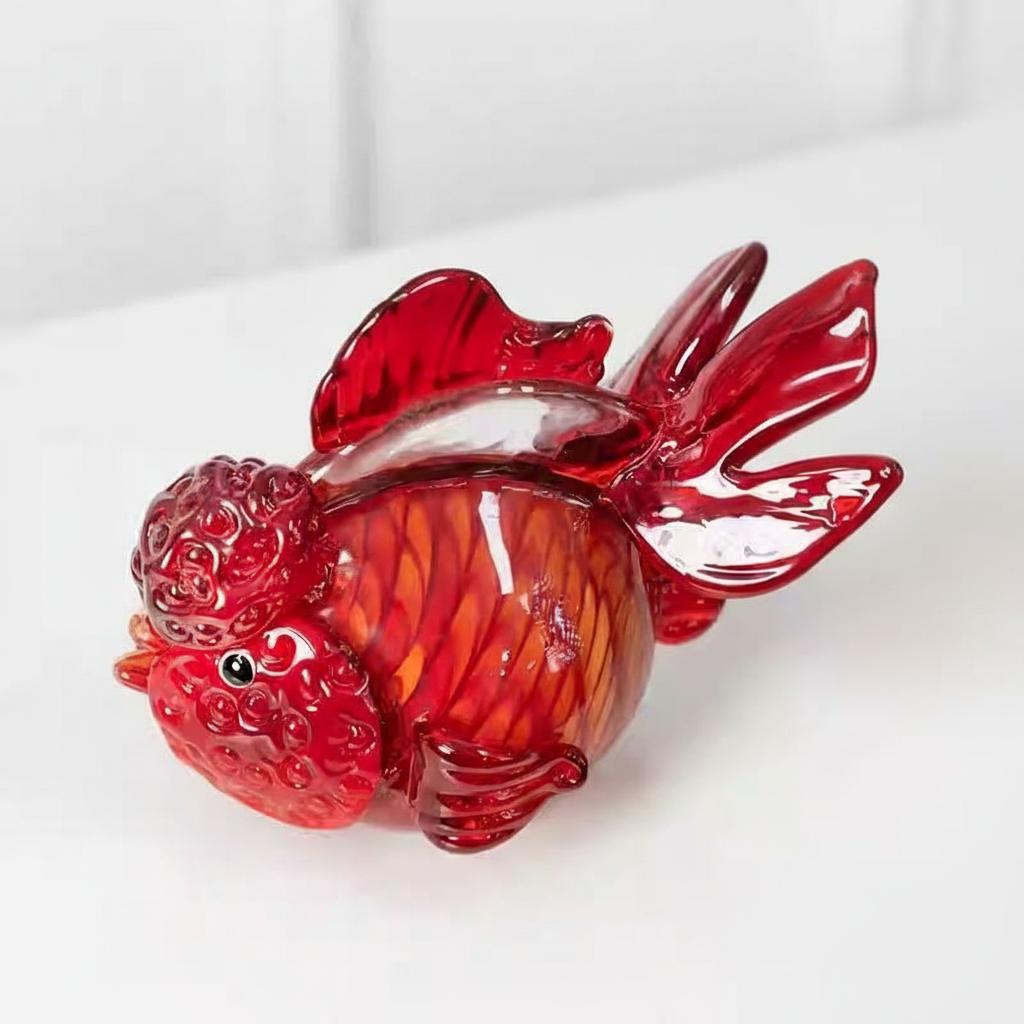 High angle detail view of red glass goldfish sculpture