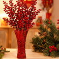 Red glass trumpet vase with floral arrangement