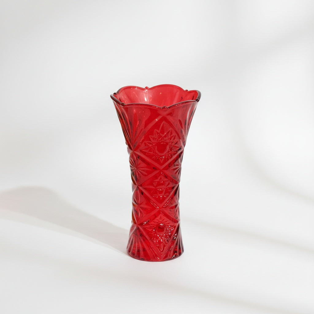 Empty red glass vase with geometric pattern