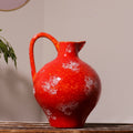 Red glazed ceramic pitcher vase front view