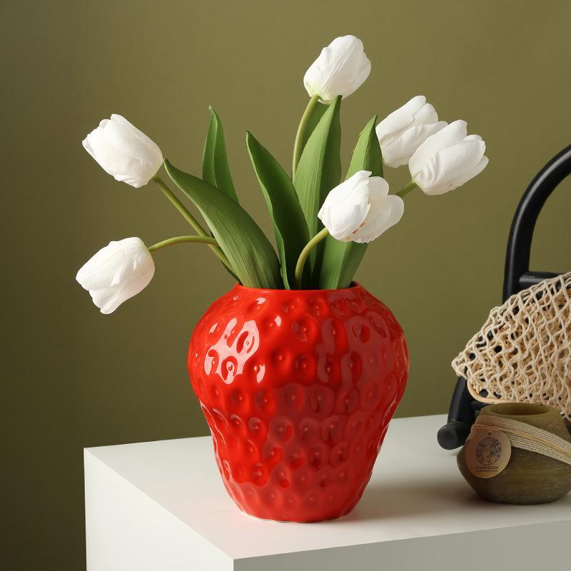 Ceramic strawberry vase with white tulips