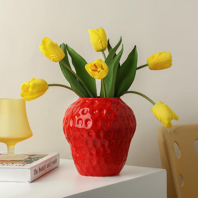 Lifestyle shot of strawberry vase with yellow tulips