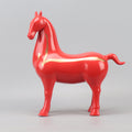 Side view of red ceramic horse sculpture with gold accent