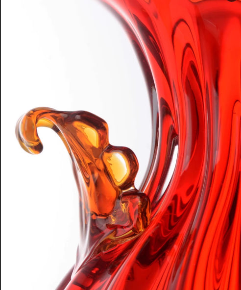 Detail shot of applied amber glass handle on red fluted body