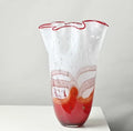 Large art glass vase with red base and white ruffled top
