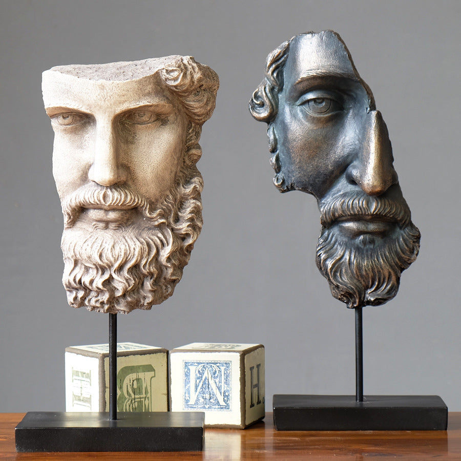 Front view of white and bronze finish fragmented bust statues