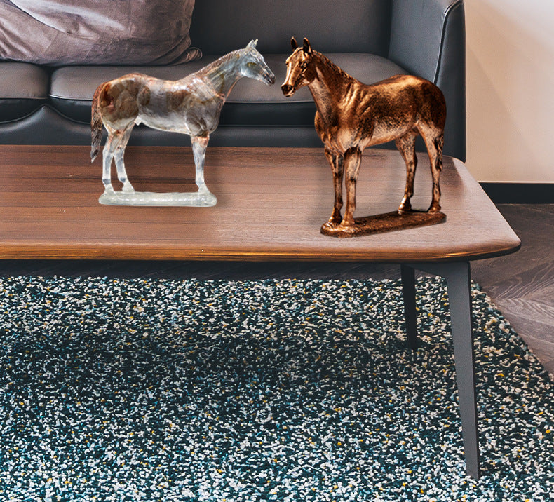 Two horse sculptures displayed on living room coffee table