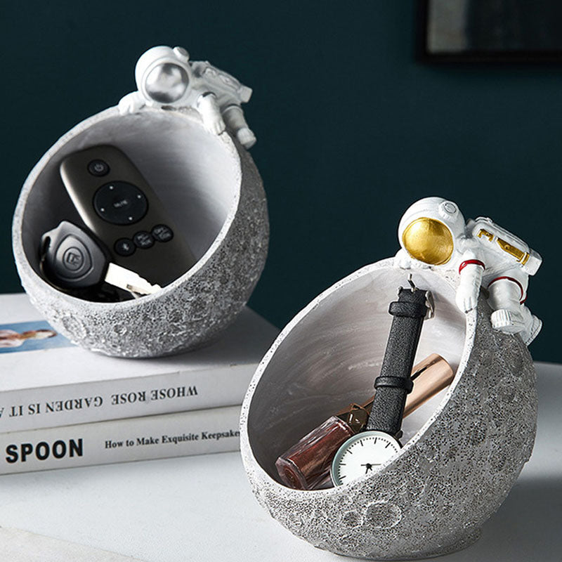 Silver astronaut moon bowl holding remote and keys