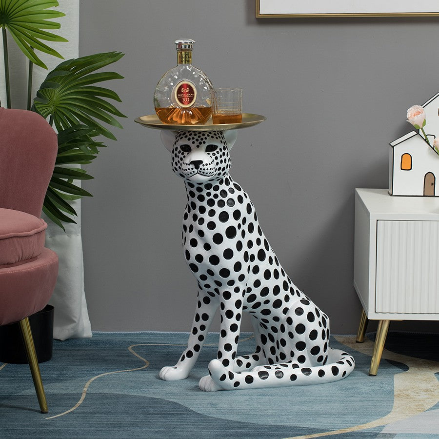 Front view of spotted leopard side table with gold tray and props