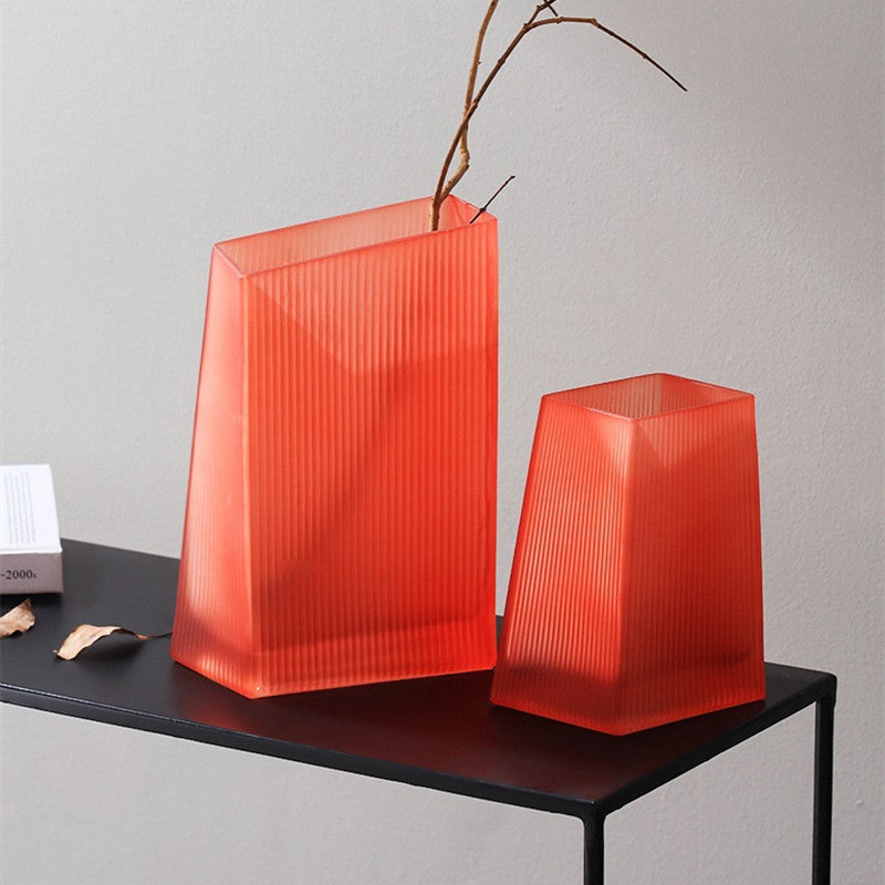 Ribbed orange glass geometric vases with botanicals