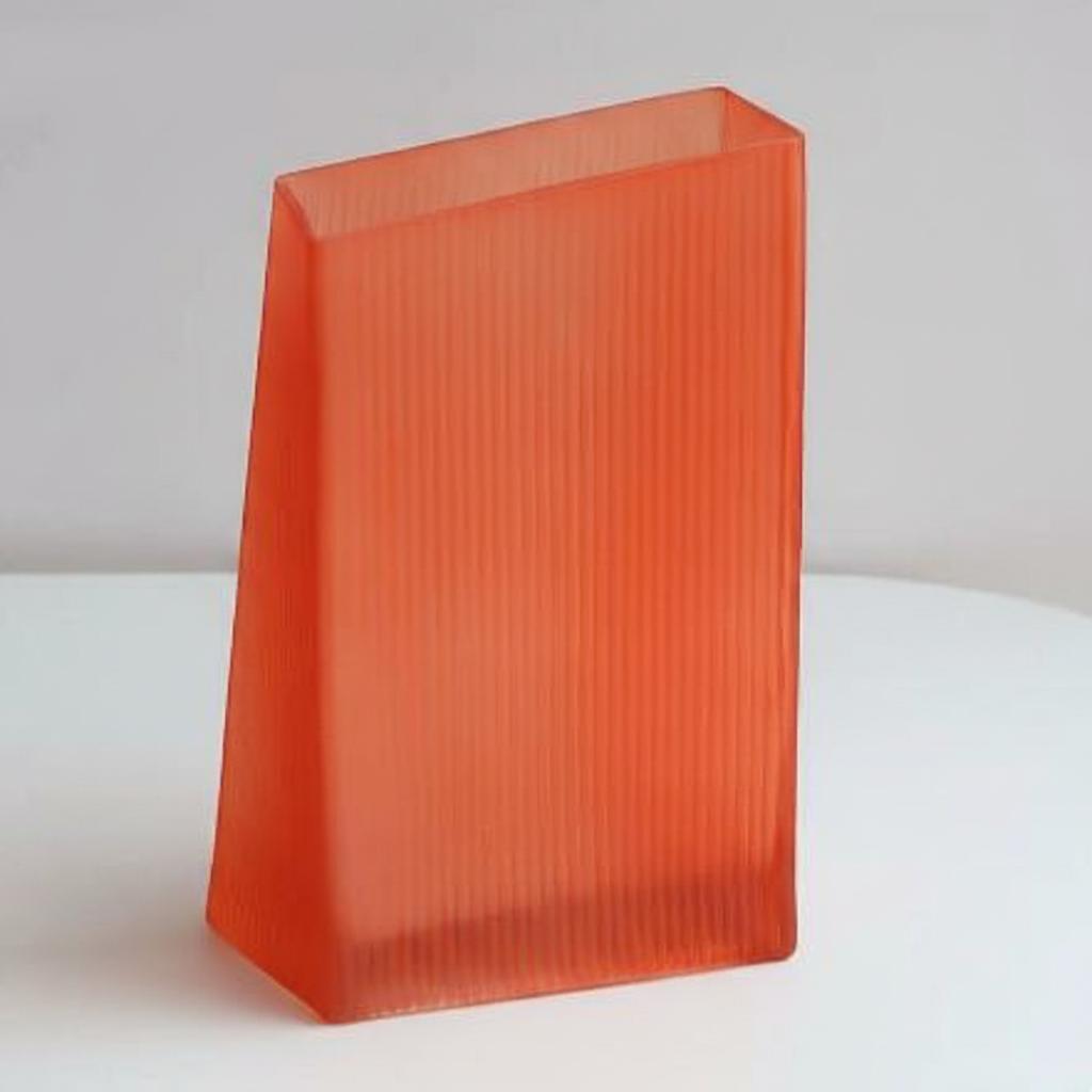 Front view of tall ribbed orange glass vase