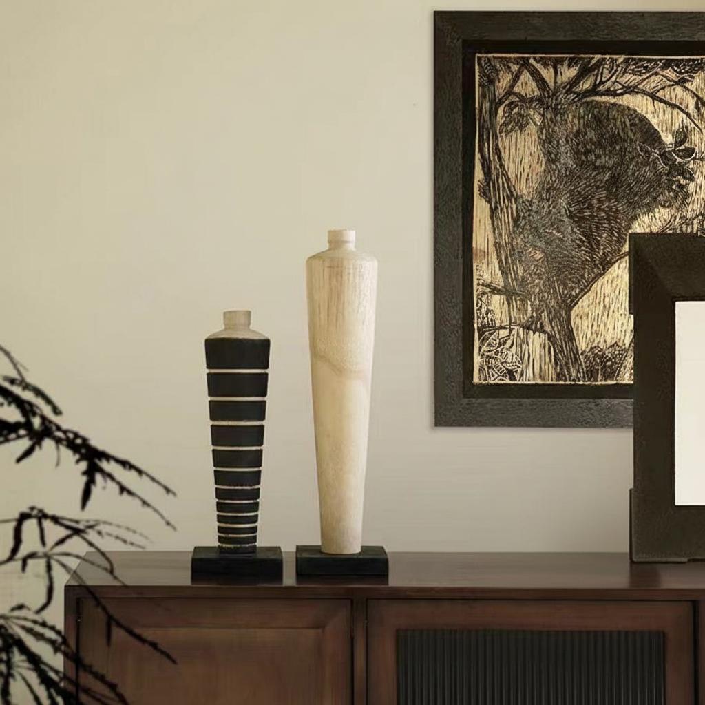 Lifestyle setting of wooden totem sculptures with artwork